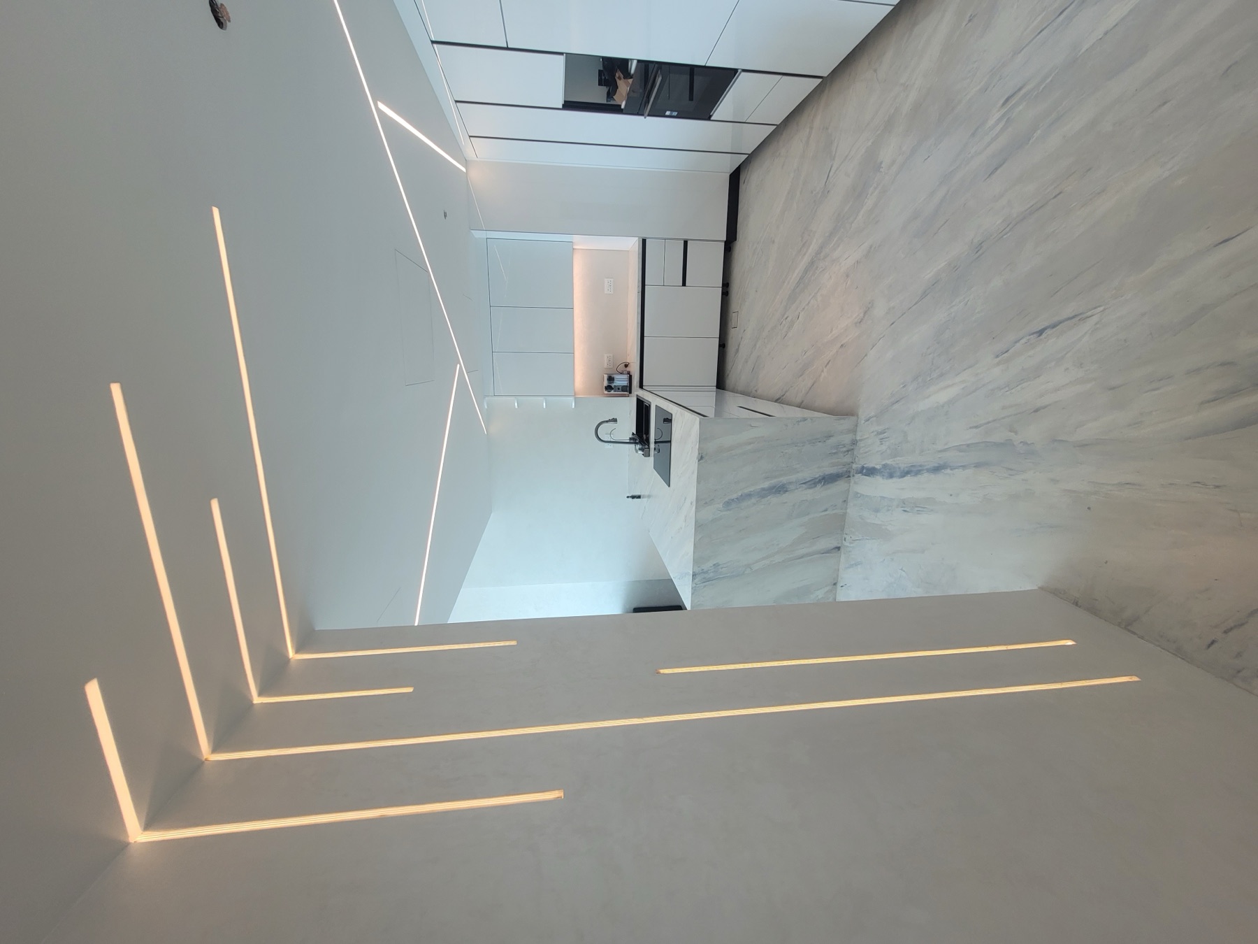 White private residence with continuous mineral finishes and integrated lighting